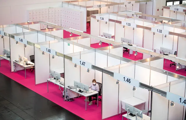 Employees set up workstations at the central location for the Contact Tracing Teams (CTT) in a hall of the trade fair in Munich, Bavaria, Germany, 30 November 2020. From 01 December, up to 500 employees of the City of Munich, the German Federal Armed Forces and support forces from the police, the Free State and the Robert Koch Institute (RKI) will be deployed in a hall at the Munich Trade Fair Centre to track down people infected with the coronavirus. (Photo by Lukas Barth-Tuttas/EPA/EFE)