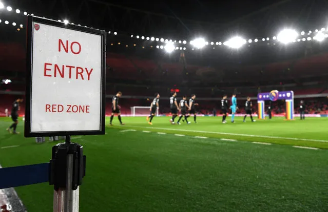 The Burnley players walk out for the match with a No Entry Red Zone sign signaling the border of the Covid-19 safe zone of during the Premier League match between Arsenal and Burnley at Emirates Stadium on December 13, 2020 in London, England. A limited number of spectators (2000) are welcomed back to stadiums to watch elite football across England. This was following easing of restrictions on spectators in tiers one and two areas only. (Photo by Laurence Griffiths/Getty Images)