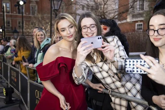 English actress Jodie Comer poses for selfies with fans upon arrival at the Olivier Awards in London, Sunday, April 2, 2023. (Photo by Vianney Le Caer/Invision/AP Photo)
