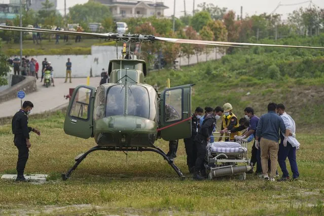 Hospital staff get ready to evacuate as a helicopter carrying injured Indian climber Anurag Maloo who was rescued from Annapurna region lands at Medicity hospital in Kathmandu, Nepal, Thursday, April 20, 2023. The Indian climber who fell into a 300-meter (980-foot) crevasse on Mount Annapurna on Monday was rescued Thursday. (Photo by Niranjan Shrestha/AP Photo)