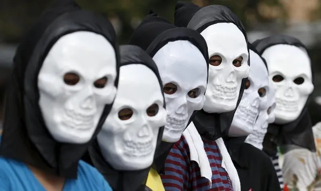 Filipino environmental activists wear skull masks as they take part in a global protest action ahead of the 2015 Paris Climate Conference, known as the COP21 summit, in Quezon city, Metro Manila Philippines November 28, 2015. (Photo by Erik De Castro/Reuters)