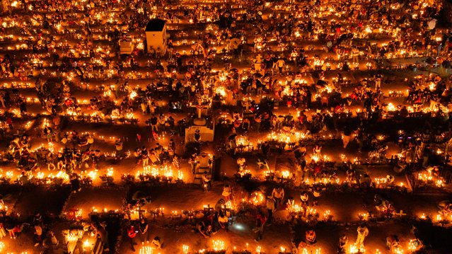 The town cemetery filled with flowers, candles and music as people celebrate Day of the Dead throughout the afternoon and evening in Guerrero, Mexico on November 1, 2025. (Photo by Cristian Leyva/NurPhoto/Rex Features/Shutterstock)