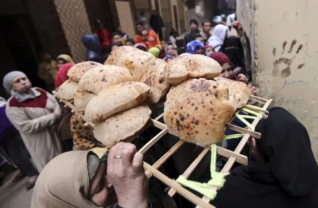 A woman walks away after buying bread at a bakery in Cairo, January 8, 2015. (Photo by Mohamed Abd El Ghany/Reuters)