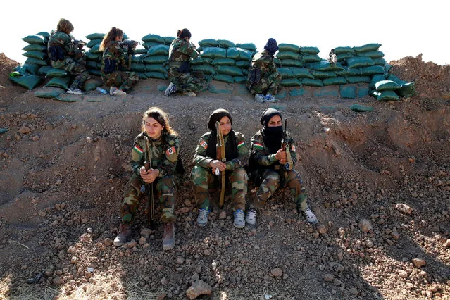 Iranian-Kurdish female fighters hold their weapons during a battle with Islamic State militants in Bashiqa, near Mosul, Iraq on November 3, 2016. (Photo by Ahmed Jadallah/Reuters)