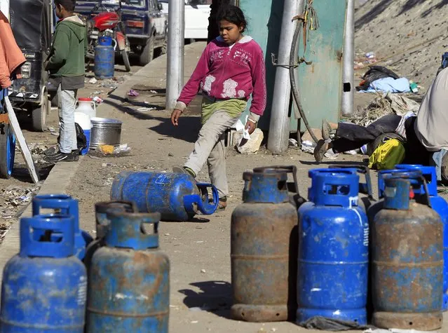 A girl waits to buy gas cylinders at a distribution point in Cairo January 19, 2015. (Photo by Mohamed Abd El Ghany/Reuters)