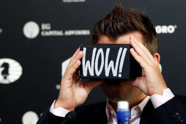 World chess champion Magnus Carlsen looks through a virtual reality viewer during a news conference ahead of the 2016 World Chess Championship in New York City, U.S., November 10, 2016. (Photo by Brendan McDermid/Reuters)