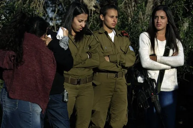 Friends and relatives of of Staff Sergeant Dor Chaim, mourn during his funeral in Moshav Shtulim, southern Israel, Thursday, January 29, 2015. Israeli Prime Minister Benjamin Netanyahu on Thursday said that Iran is to blame for a deadly flare-up along the Israeli-Lebanese border the previous day, the deadliest escalation in the disputed zone since the 2006 war between Hezbollah and Israel. (Photo by Tsafrir Abayov/AP Photo)