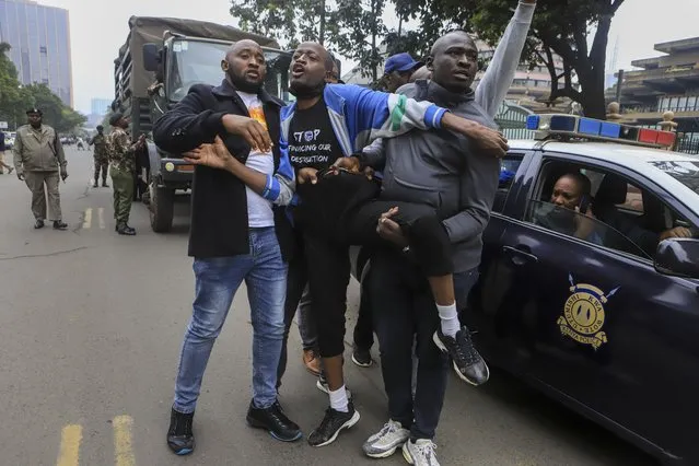 A protester is detained by plain-clothes security forces during a demonstration against the Finance Bill, in downtown Nairobi, Kenya Thursday, June 15, 2023. Kenyans are preparing for tough times after lawmakers late Wednesday, June 21, 2023 approved tax increases that are even unpopular with supporters of the president who once vowed to reduce the cost of living. (Photo by AP Photo/Stringer)