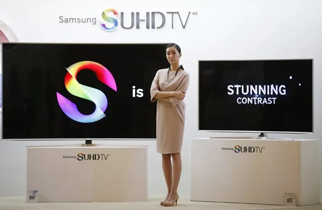 A model stands next to Samsung Electronic's S'UHD smart television sets during its launch event in Seoul February 5, 2015. (Photo by Kim Hong-Ji/Reuters)