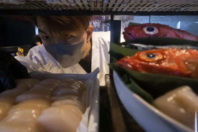 A chef prepares fish at a sashimi restaurant in Hong Kong, Friday, July 14, 2023. As Tokyo plans to discharge treated radioactive wastewater into the sea, Hong Kong’s Japanese restaurants and seafood suppliers are bracing for a slump in business under a potential ban by Hong Kong on aquatic products from 10 Japanese regions. (Photo by Louise Delmotte/AP Photo)