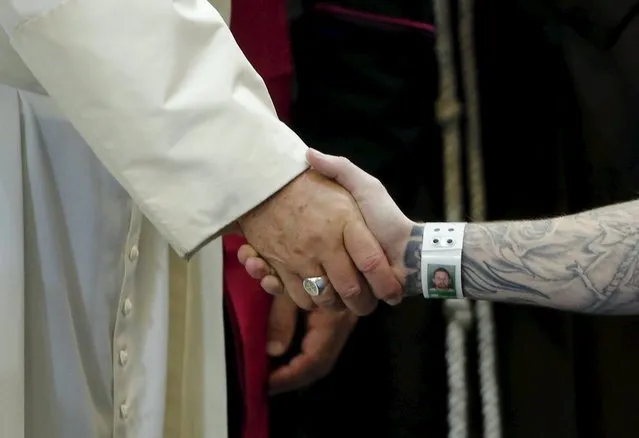 Pope Francis shakes hands with an inmate as he meets with prisoners at Curran-Fromhold Correctional Facility in Philadelphia, United States September 27, 2015. (Photo by Jonathan Ernst/Reuters)