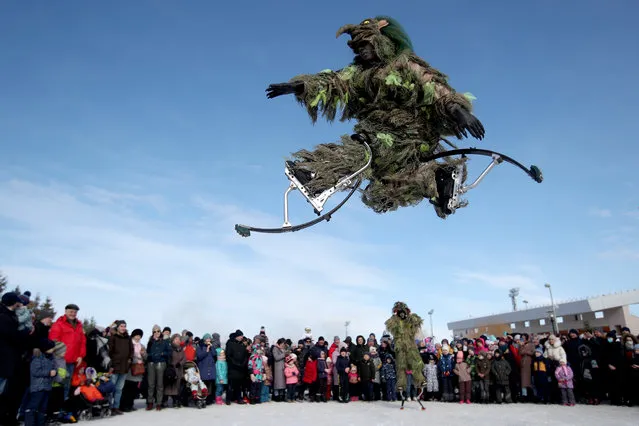 Men on jumping stilts perform during Nowruz celebrations at the Kazan multifunctional equestrian center on March 21, 2021. Nowruz, also known as the Iranian or the Persian New Year, commemorates the first day of spring; it is celebrated by various Turkic and Iranian ethnic groups on the spring equinox (March 21). (Photo by Yegor Aleyev/TASS)