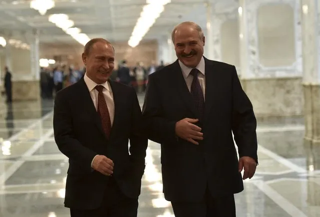 Russia's President Vladimir Putin (L) and Belarus' President Alexander Lukashenko laugh while walking before a meeting on resolving the Ukrainian crisis in Minsk, February 11, 2015. (Photo by Mykola Lazarenko/Reuters)