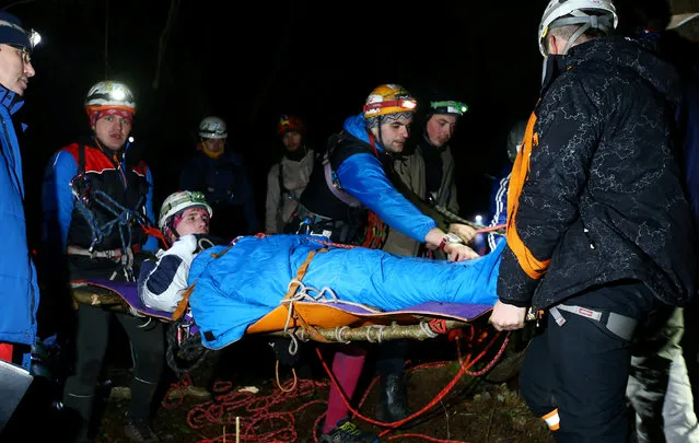 Belarussian tourists carry a man on a stretcher as they take part in “Search and rescue operations – 2016”, a three-day competition, near the village of Priselki, Belarus, November 25, 2016. Photo taken November 25, 2016. (Photo by Vasily Fedosenko/Reuters)