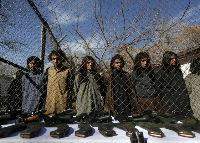 Pakistani Taliban fighters, who were arrested by Afghan border police, stand during a presentation of seized weapons and equipment to the media in Kabul, Afghanistan January 5, 2016. (Photo by Omar Sobhani/Reuters)