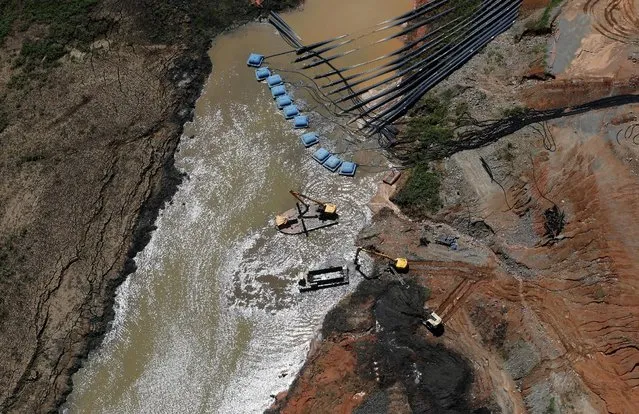 Machines from SABESP (bottom R), a Brazilian enterprise of Sao Paulo state that provides water and sewage services to residential, commercial and industrial areas, work next to pumps from the Jaguari dam station, which provides water to the SABESP systems, during a drought in Braganca Paulista, Sao Paulo state February 12, 2015. (Photo by Paulo Whitaker/Reuters)