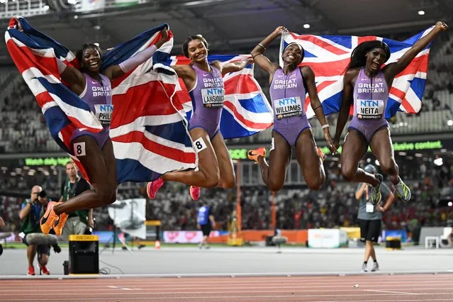 (L to R) Britain's Asha Philip, Imani Lansiquot, Bianca Williams, and Daryll Neita jump in the air as they pose for a group photo after taking third-place in the women's 4x100m relay final during the World Athletics Championships at the National Athletics Centre in Budapest on August 26, 2023. (Photo by Jewel Samad/AFP Photo)