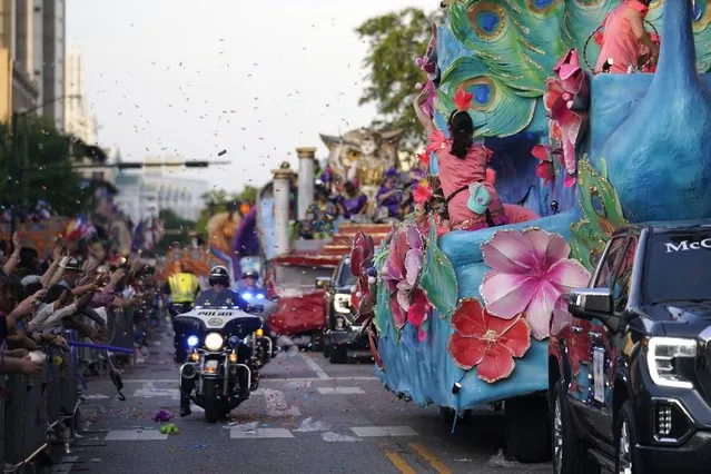 Police ride between crowds and floats during a parade dubbed “Tardy Gras”, to compensate for a cancelled Mardi Gras due to the COVID-19 pandemic, in Mobile, Ala., Friday, May 21, 2021. (Photo by Gerald Herbert/AP Photo)
