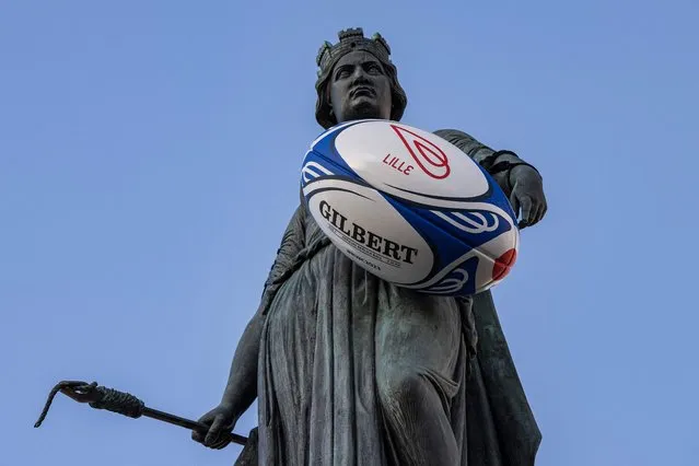 A huge rugby ball is installed on the Column of the Goddess statue, a Memorial monument for the Siege of Lille in 1792 located in the Grand'Place square in Lille, on September 13, 2023, during the France 2023 Rugby World Cup. (Photo by Sameer Al-Doumy/AFP Photo)