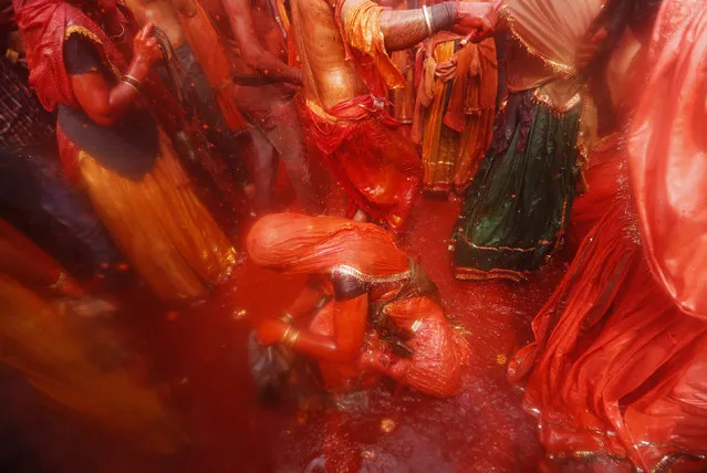A woman sits in a puddle of coloured water as she takes part in “Huranga” at the Dauji temple, near the northern Indian city of Mathura, March 7, 2015. (Photo by Adnan Abidi/Reuters)