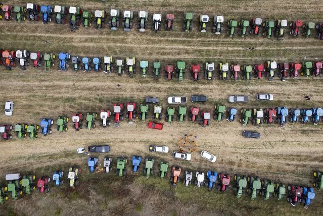 This aerial picture shows tractors parked in a field during a protest against the lifting of ban on imports of grain coming from Ukraine, in Dolni Bogrov, near Sofia, on September 19, 2023. Bulgaria decided on September 14 not to extend a ban on Ukrainian grain imports in five eastern EU nations. In June, the EU agreed to restrict Ukrainian grain imports to five member states, seeking to protect their farmers who blamed the imports for a slump in prices on local markets. (Photo by Nikolay Doychinov/AFP Photo)