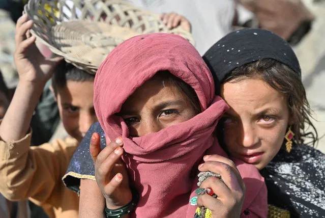 Children stand at a camp for internally displaced people (IDP) where new apartment buildings are located in Kabul on June 21, 2021. (Photo by Adek Berry/AFP Photo)