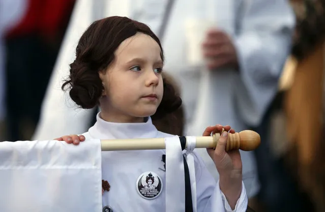 Addy Longlois, 7, dressed as Princess Leia, walks in a parade in honor of actress Carrie Fisher, who played Princess Leia in the “Star Wars” movie series, in New Orleans, Friday, December 30, 2016. (Photo by Gerald Herbert/AP Photo)