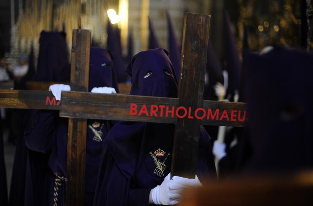 Hooded penitents  from “El Calvario” brotherhood take part during a Holy Week procession in Cordoba, Spain, Wednesday, April 1, 2015. (Photo by Manu Fernandez/AP Photo)