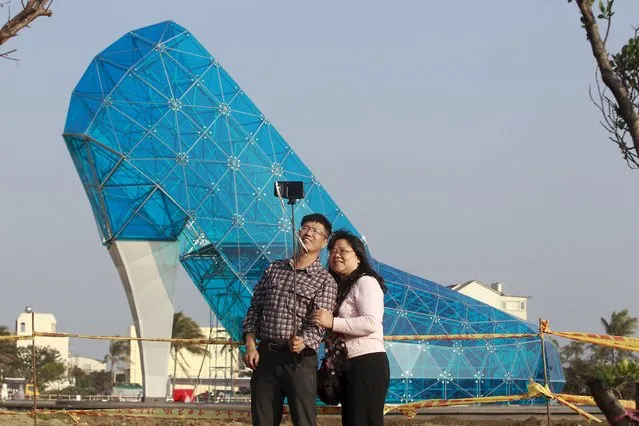 People take selfies in front of a shoe-shaped church in Chiayi, southern Taiwan, January 18, 2016. The church, which is about 17 meter (55 feet) tall and 11 meter (36 feet) wide, took three months and about $685,000 to build. It is expected to open in February 2016, before the Lunar New Year, according to the Chiayi county government official. (Photo by Pichi Chuang/Reuters)