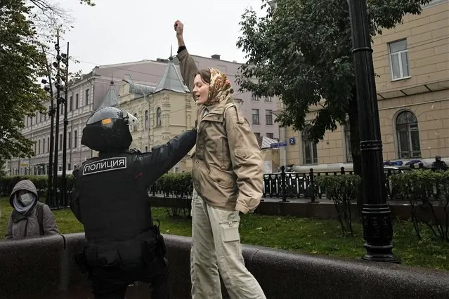 A Police officer detains a demonstrator during a protest against a partial mobilization in Moscow, Russia, Saturday, September 24, 2022. (Photo by AP Photo/Stringer)