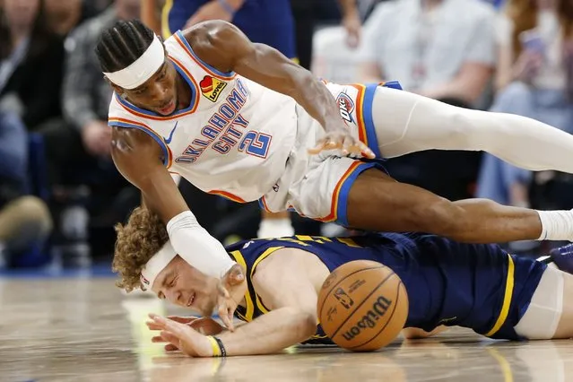 Oklahoma City Thunder guard Shai Gilgeous-Alexander (2) and Golden State Warriors guard Brandin Podziemski collide while chasing the ball during the second half of an NBA basketball game Friday, December 8, 2023, in Oklahoma City. (Photo by Nate Billings/AP Photo)