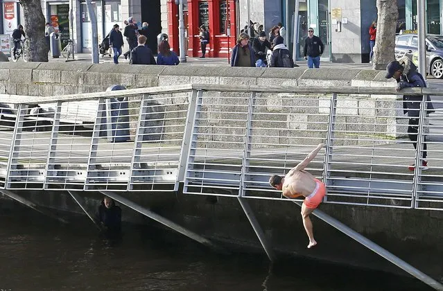 A member of the public stripped to his underwear looks at rescuing a man that had fallen into the river in central Dublin, Ireland February 26, 2016. (Photo by Darren Staples/Reuters)