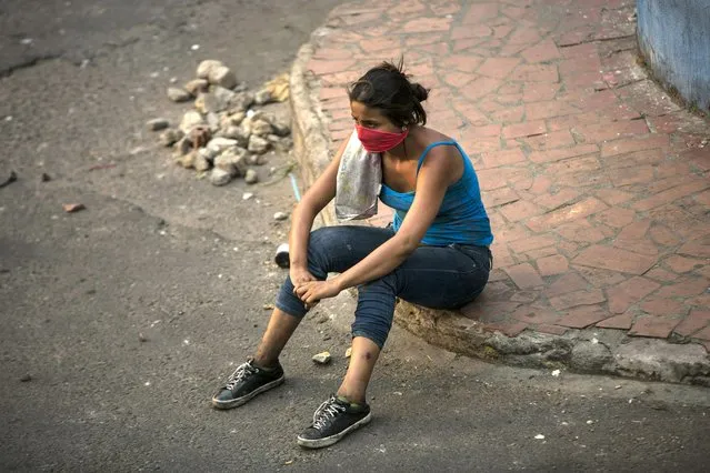 An opposition demonstrator rests after clashing with the Bolivarian National Guard in Urena, Venezuela, near the border with Colombia, Saturday, February 23, 2019. (Photo by Rodrigo Abd/AP Photo)
