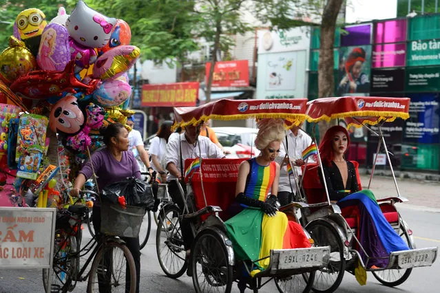 Participants ride on traditional three- wheeler rickshaws during a gay pride parade to advocate gay rights in Hanoi on November 11, 2018. (Photo by Nhac Nguyen/AFP Photo)