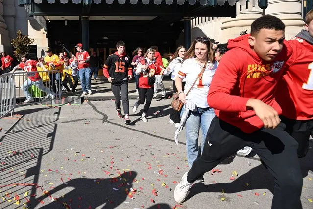 People flee after shots were fired near the Kansas City Chiefs' Super Bowl LVIII victory parade on February 14, 2024, in Kansas City, Missouri. A shooting incident at a packed parade Wednesday to celebrate the Kansas City Chiefs' Super Bowl victory killed one person and injured nine others, the city fire department said. (Photo by Andrew Caballero-Reynolds/AFP Photo)