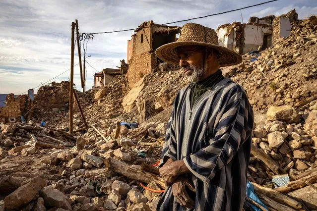 A man stands amid the rubble of destroyed buildings in the earthquake-hit village of Douzrou, in central Morocco on February 13, 2024. Moroccan authorities said some 3,000 people died during the September 8 earthquake that left more than 60,000 dwellings destroyed. (Photo by Fadel Senna/AFP Photo)