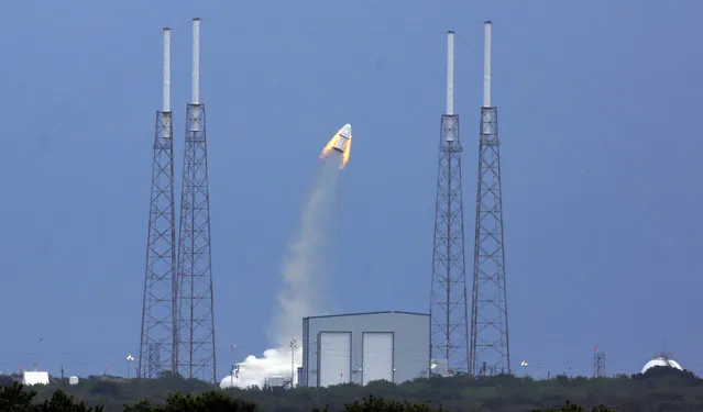 SpaceX's Dragon capsule launches, Wednesday, May 6, 2015, from Cape Canaveral, Fla. SpaceX fired the mock-up capsule to test the new, super-streamlined launch escape system for astronauts. (Photo by Red Huber/AP Photo/Orlando Sentinel)
