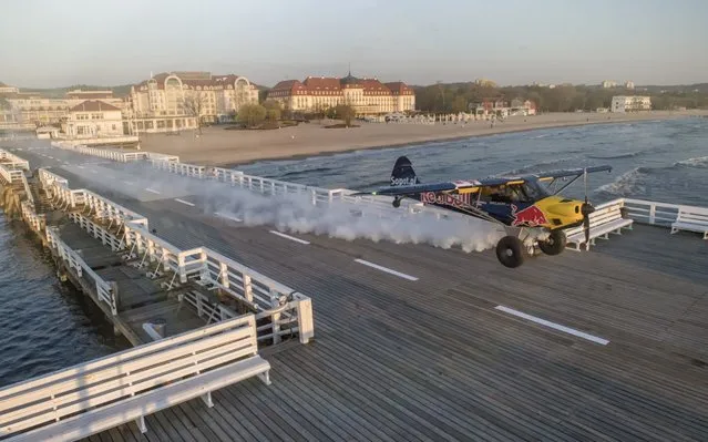 Polish pilot Lukasz Czepiela takes off and lands on Europe's longest pier – Sopot pier in Poland on April 26, 2019. Lukasz is renowned for his precision flying but required pinpoint accuracy to perform the tight landing much to the shock of tourists looking on. (Photo by Red Bull/South West News Service)