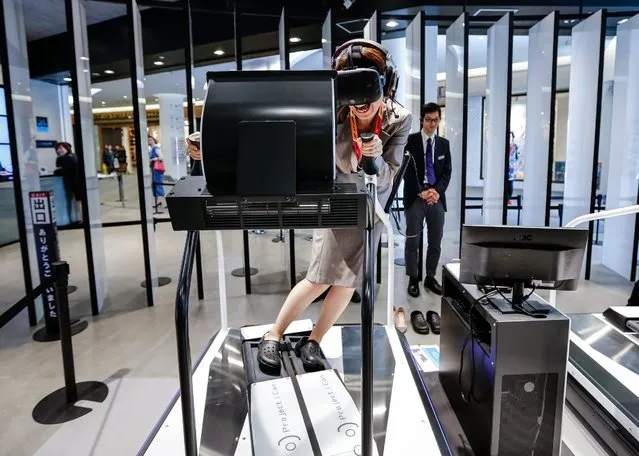 A woman tests the Ski Rodeo game at the new Bandai Namco “VR Zone: Project I Can” experience center in a shopping mall in Tokyo, Japan, 11 April 2016. The virtual reality center will allow people to try out six different VR reality simulation games in which Bandai Namco will receive valuable feedback on how to improve their virtual reality simulation technology. The center opens to the general public for a limited time from 15 April. (Photo by Christopher Jue/EPA)