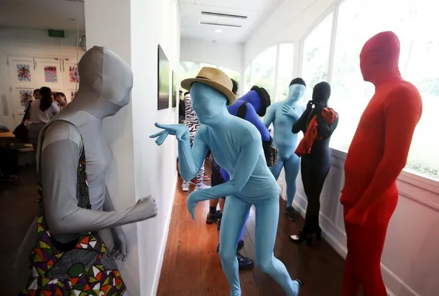 Participants wearing Zentai costumes, or skin-tight bodysuits from head to toe, mingle before their march down the shopping district of Orchard Road during Zentai Art Festival in Singapore May 23, 2015. Close to 50 participants strutted down the busy shopping district during the Zentai art festival which is jointly organized by the Japanese embassy. The festival includes performances and discussions on Zentai from May 22 to from June 5. (Photo by Edgar Su/Reuters)