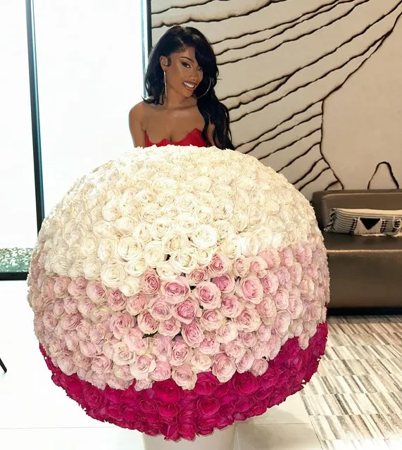 American rapper Megan Thee Stallion in the first decade of April 2024 receives an enormous bouquet of flowers. (Photo by theestallion/Instagram)