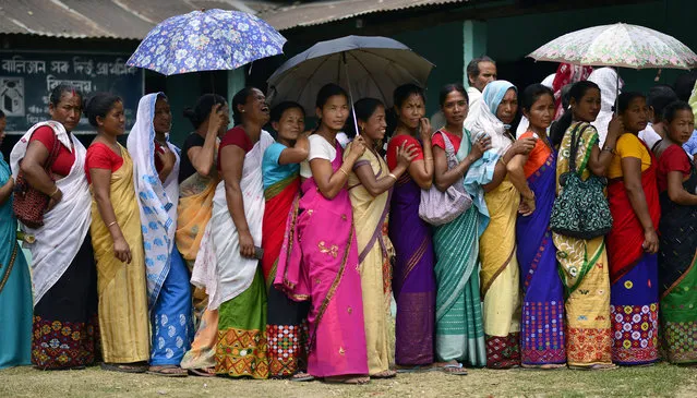 Indian voters wait to cast their votes at a polling station during the first phase of the Indian general election in Lakhimpur district, Assam state, India, April 7, 2014. Voters in India's remote north-eastern states of Assam and Tripura were casting their ballots in the first phase of the country's general elections. Polls were taking place in five of Assam's 14 constituencies and one of two constituencies in Tripura, in the first of nine phases of voting. (Photo by EPA)