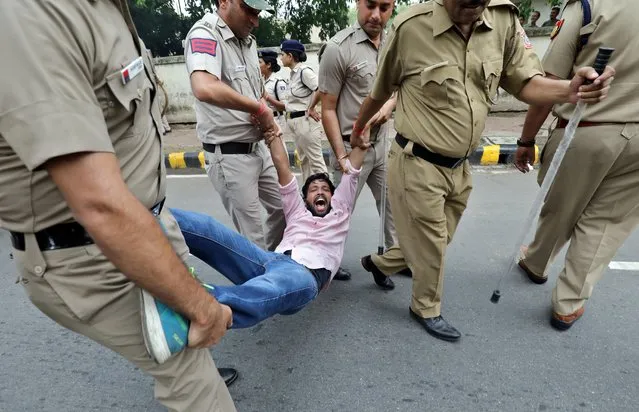 A member of the Delhi Pradesh Youth Congress reacts as he is detained by police during a protest against an amendment to the Right to Information Act, in New Delhi, July 27, 2019. (Photo by Anushree Fadnavis/Reuters)