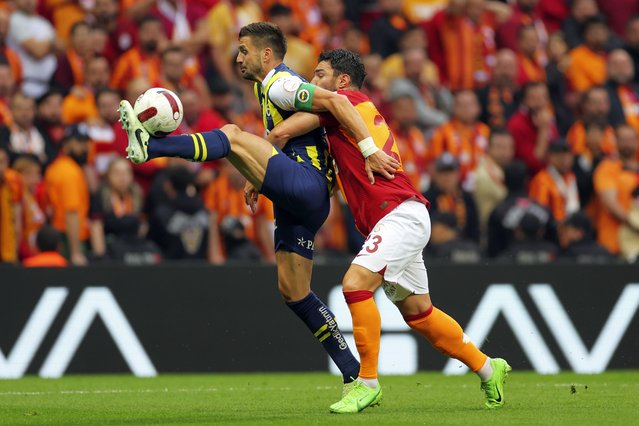 Fenerbahce's Dusan Tadic, left, fights for the ball with Galatasaray's Kaan Ayhan, during a Turkish Super Lig soccer match between Galatasaray and Fenerbahce in Istanbul, Turkey, Sunday, May 19, 2024. (Photo by AP Photo)