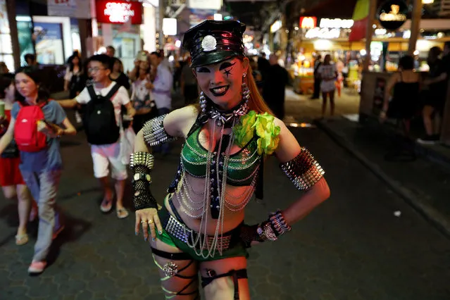 A woman promotes a go-go dance bar in Pattaya, Thailand March 25, 2017. With mascots dressed as smiling fish and a police rock band, Thai authorities launched a “Happy Zone” at the weekend to improve the image of a city notorious for sеx tourism. Stung by foreign headlines portraying the seaside resort of Pattaya as “Sin City” and “The World’s Sеx Capital”, Thailand’s junta has begun a new effort to re-brand it. Businesses in the Happy Zone are asked to make the area feel safer, there are increased security patrols, police launched a mobile phone app for visitors to summon them if an emergency occurs. (Photo by Jorge Silva/Reuters)