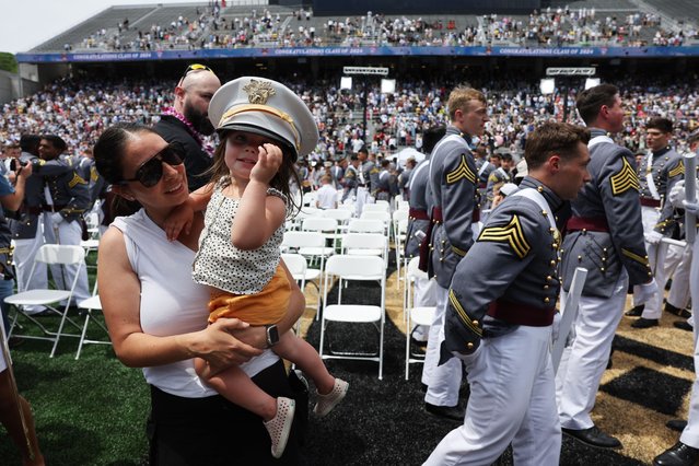 Children collect cadets hats following the West Point commencement exercises at Michie Stadium on May 25, 2024 in West Point, New York. U.S. President Joe Biden addressed the Class of 2024, which includes roughly 1,000 cadets graduating and commissioning into the Army as second lieutenants. (Photo by Spencer Platt/Getty Images)