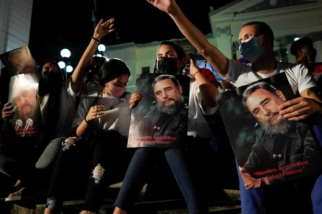 Students hold images of the late Cuban President Fidel Castro during an event commemorating the five year anniversary of his death, in Havana, Cuba, November 24, 2021. (Photo by Alexandre Meneghini/Reuters)