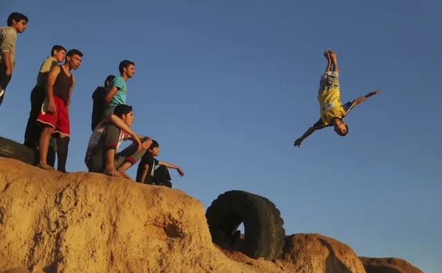 A Palestinian youth practices his parkour skills at the Shati refugee camp in Gaza City April 27, 2014. (Photo by Mohammed Salem/Reuters)