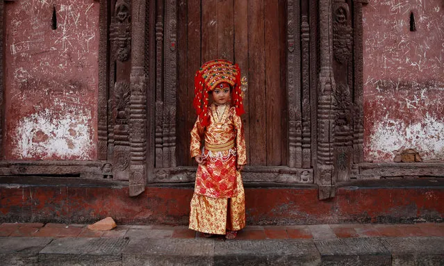 A young girl dressed as the Living Goddess Kumari participates the Kumari Puja festival, in which young girls pose as the Living Goddess Kumari and are worshipped by people in belief that their children will remain healthy, in Kathmandu, Nepal on September 11, 2019. (Photo by Navesh Chitrakar/Reuters)