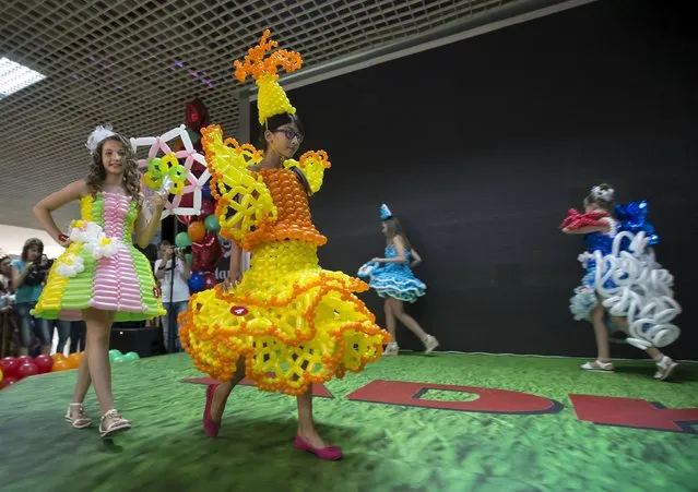 Models present outfits made with air balloons during an international festival of air balloons design in Almaty, Kazakhstan, July 9, 2015. (Photo by Shamil Zhumatov/Reuters)